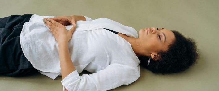 Woman in White Long Sleeve Shirt Lying on Floor